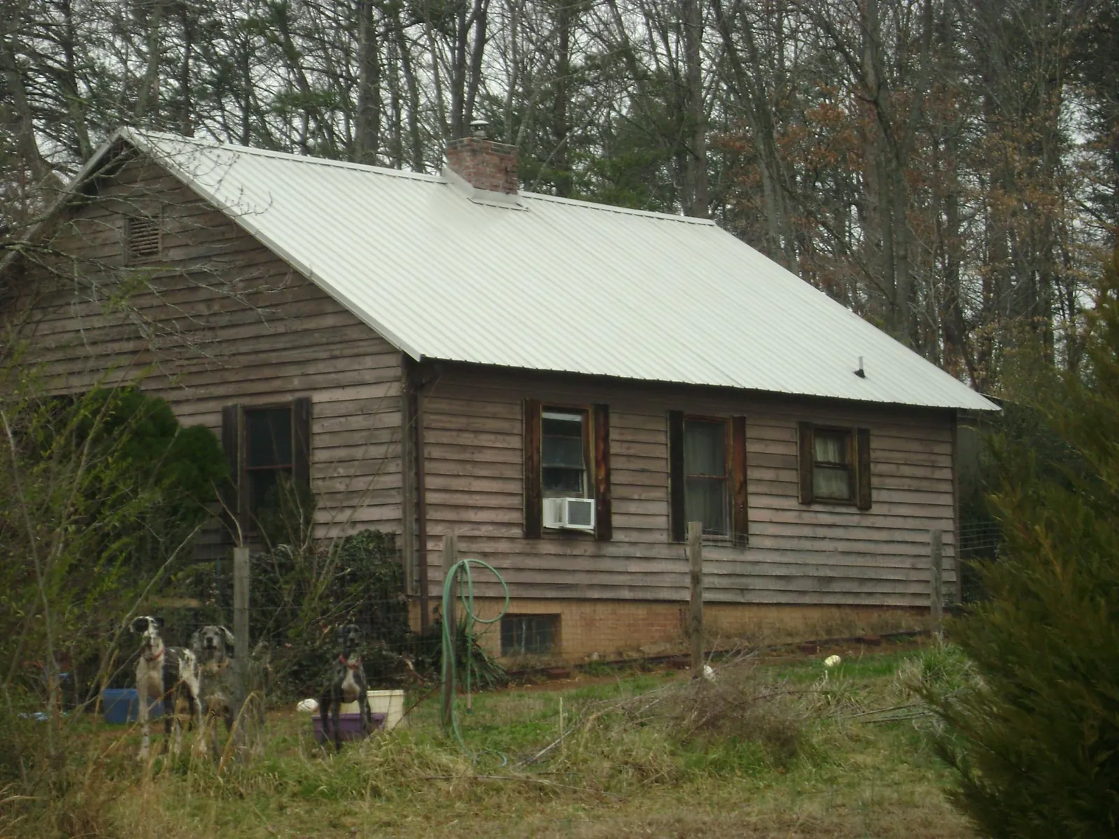 White metal roof on an old wood sided farmhouse, from a Metal Roof Installation job in White